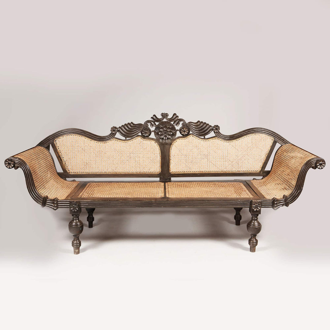 British colonial ebony sofa with carved floral details and caned seat by Collection EE20