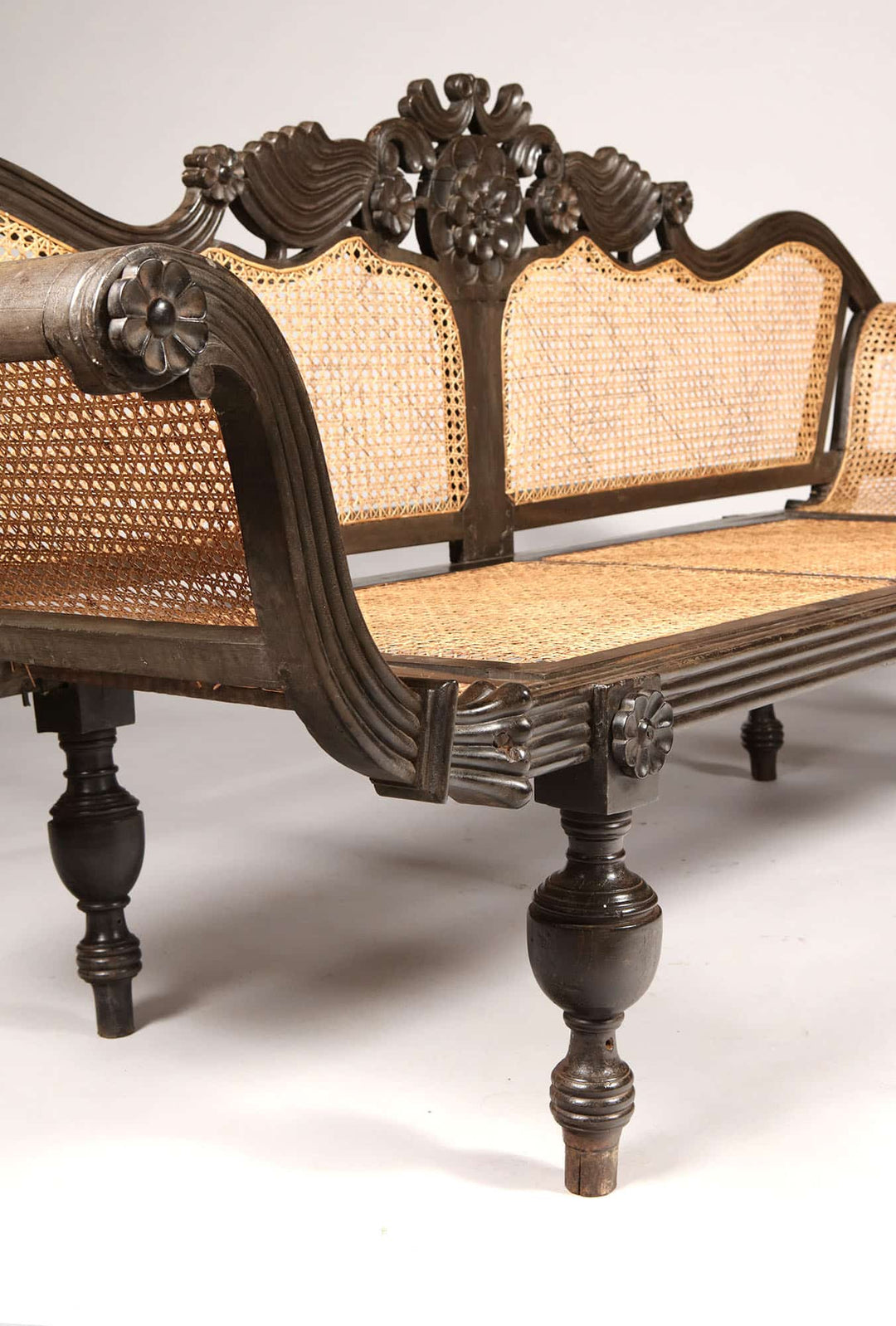 Detailed carved solid ebony sofa with caned seat and back by Collection EE20, elegant British colonial style