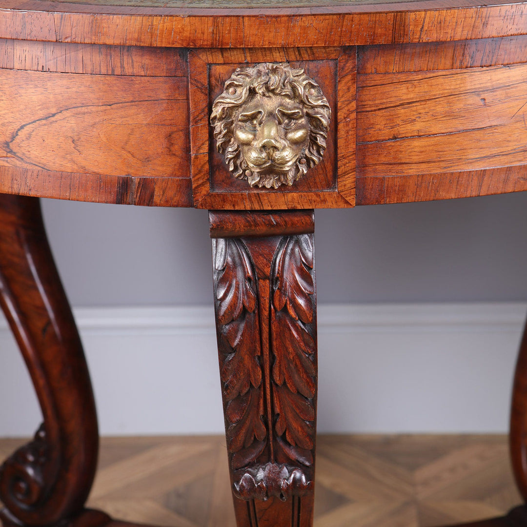 Regency Rosewood Drum Table detailed lion mask on drawer and carved scroll leg with leaf motifs in rich wood finish.