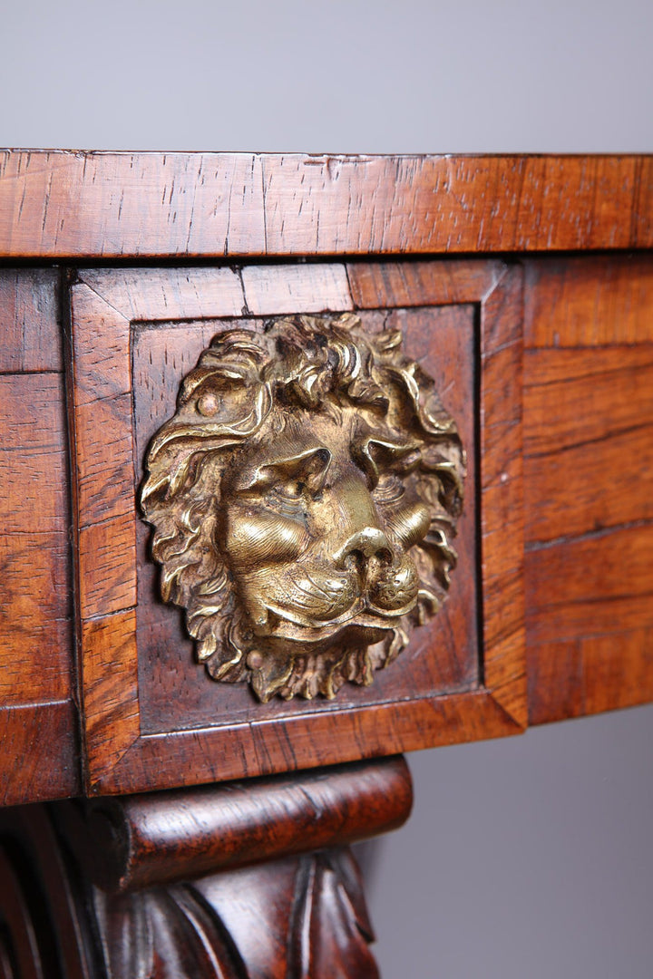 Regency Rosewood Drum Table close-up of brass lion mask drawer handle on rich rosewood woodwork.