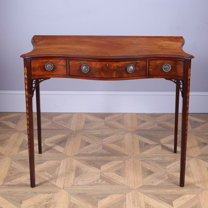 George III Hepplewhite Serpentine Side Table solid mahogany top with three drawers and silver plated ring handles.
