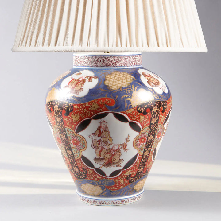 Near Pair of Japanese Imari Vases as Lamps with intricate blue red gold porcelain pattern and pleated lampshade.
