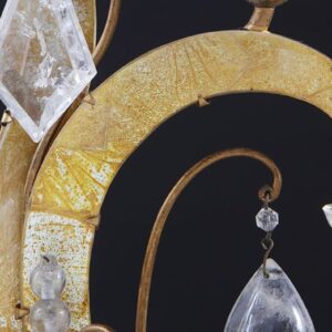 Pair of Maison Bagues Four Light Flame Candelabra with gilt flames, eglomise glass panels, and rock crystal drops on mirrored bases.