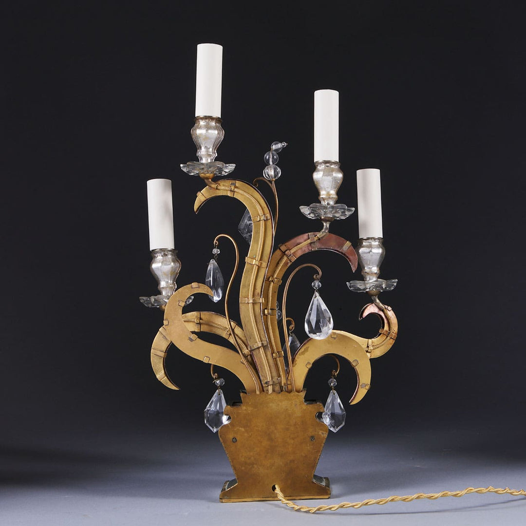 Pair of Maison Bagues Four Light Flame Candelabra with gilt flames, eglomise glass, and crystal drops on mirrored bases.