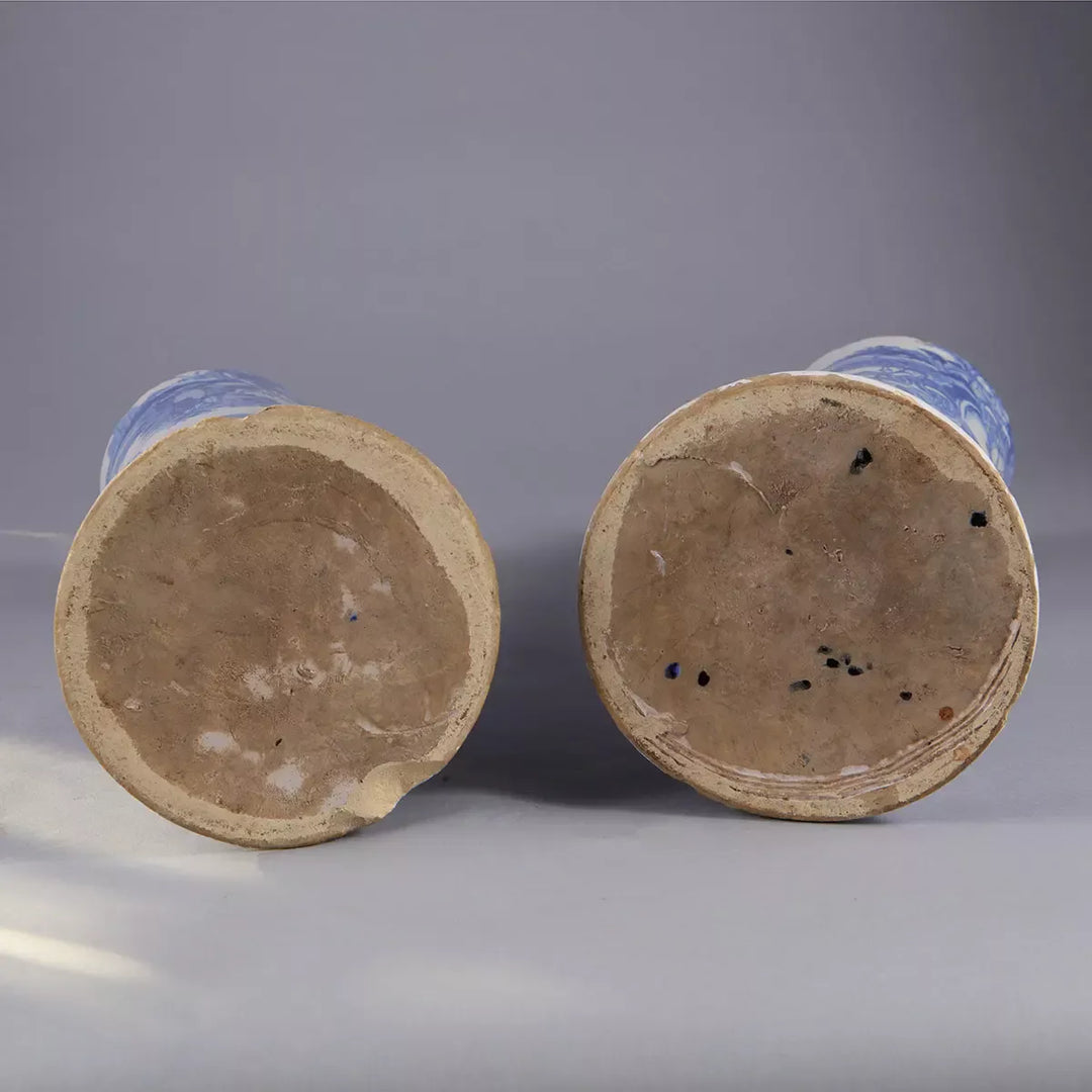 Pair of Blue and White Delft Trumpet Vases as Table Lamps shown from the bottom with visible clay bases against gray background