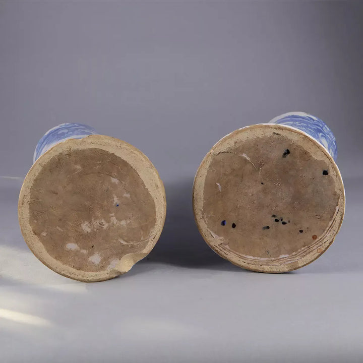 Pair of Blue and White Delft Trumpet Vases as Table Lamps shown from the bottom with visible clay bases against gray background