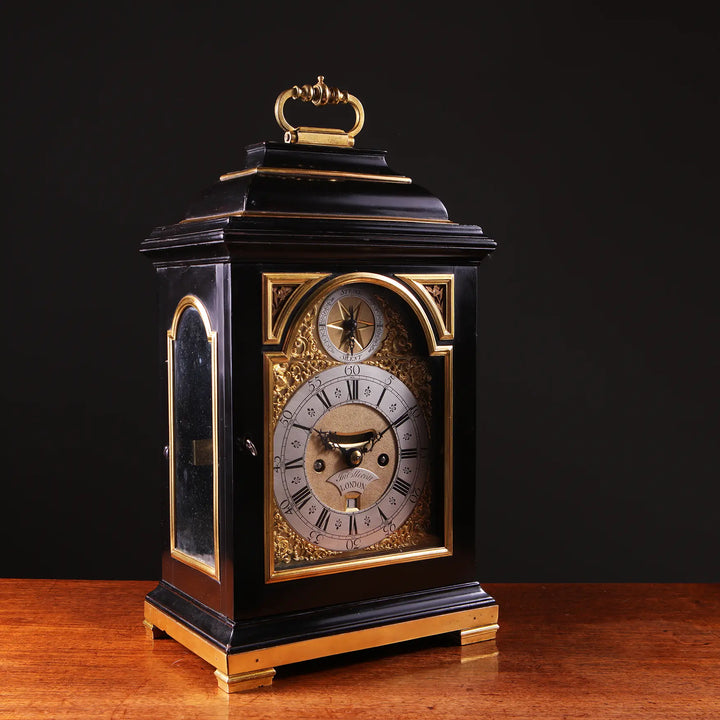 Mid 18th century ebony and gilt bronze bracket clock by John Ellicott, offered by Nicholas Wells Antiques.