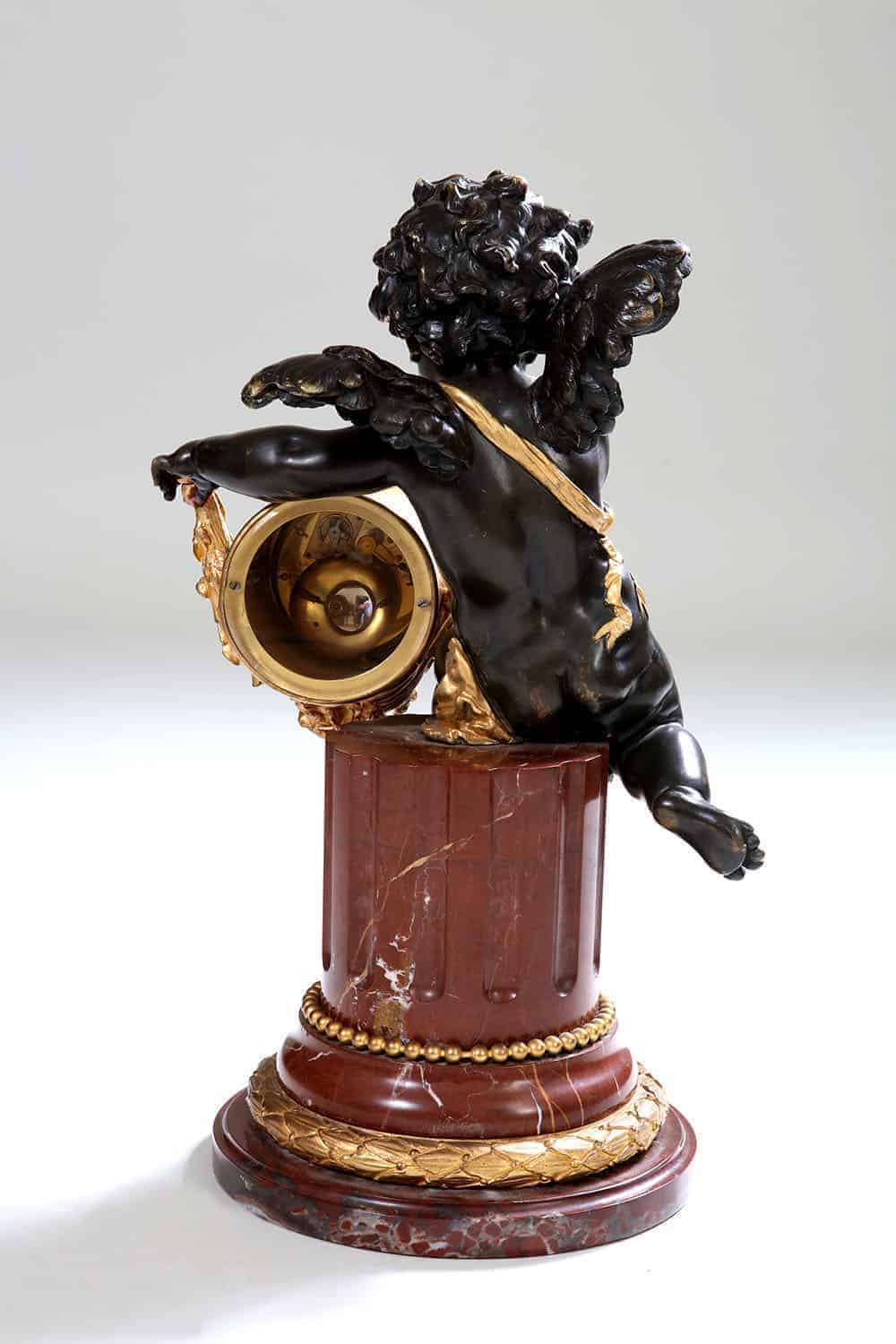 Back view of gilt bronze cherub clock on rouge marble column by Nicholas Wells Antiques circa 1870