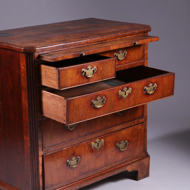 George I Walnut Chest of Drawers with feather banding, brass handles, and bracket feet, early 18th century English antique.
