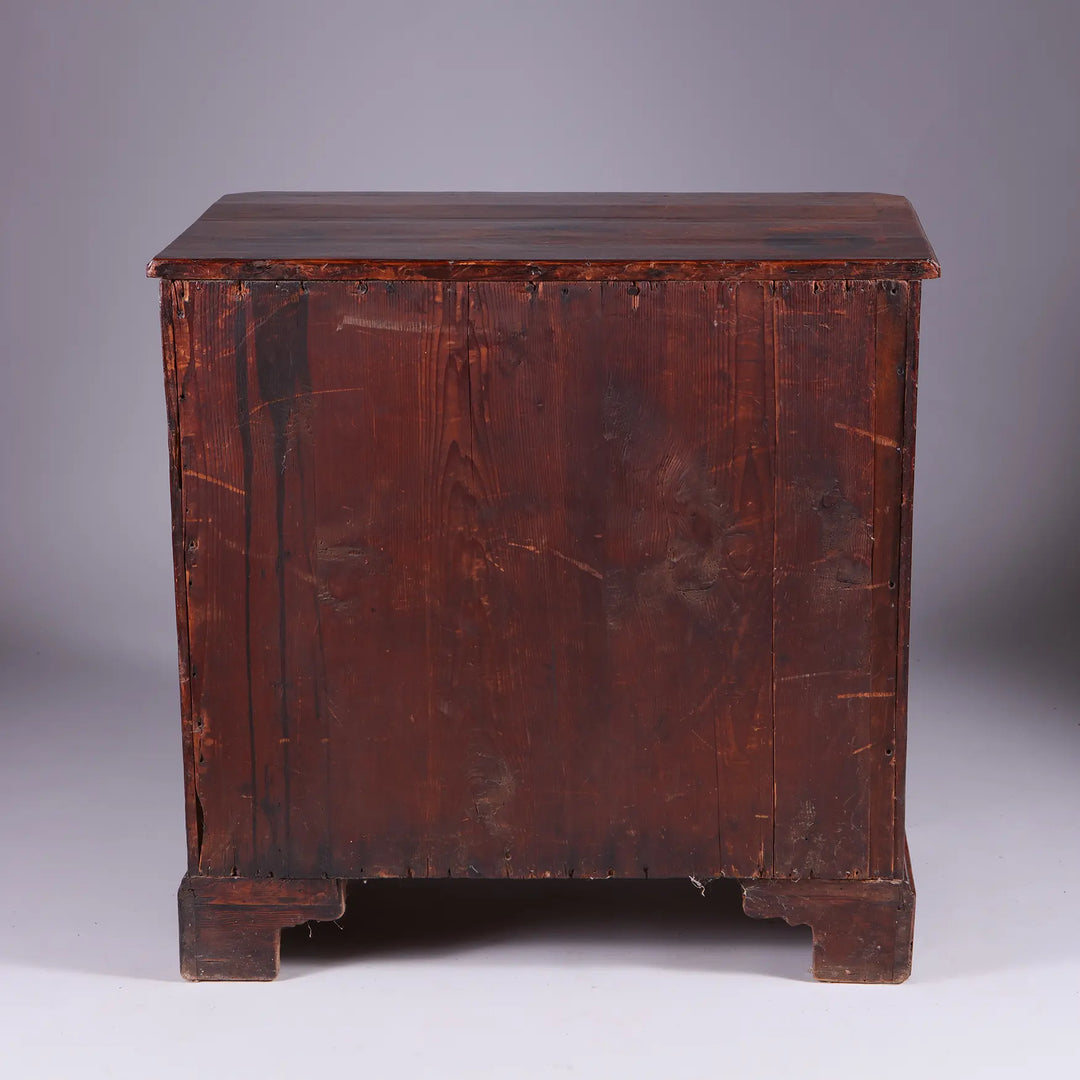 George I Walnut Chest of Drawers showing the back with aged wood and bracket feet, circa 1715 England.