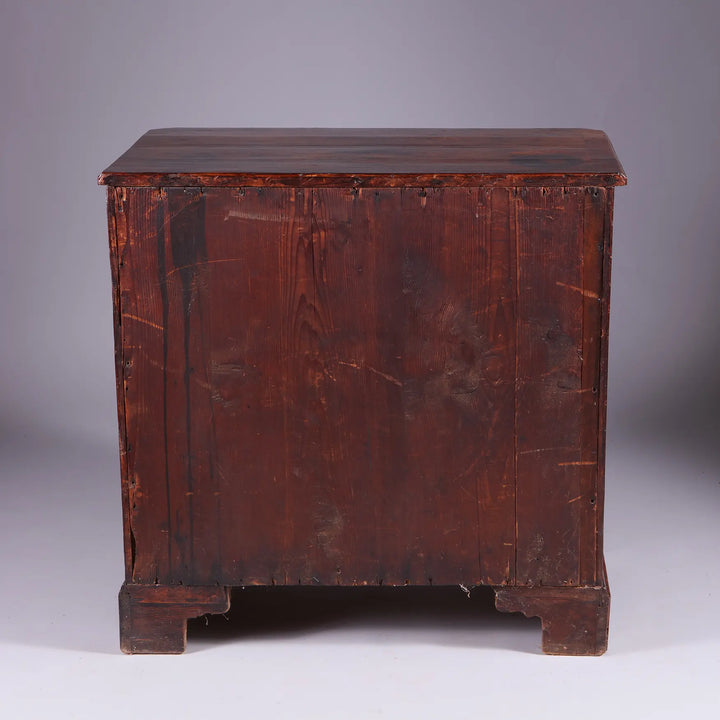 George I Walnut Chest of Drawers showing the back with aged wood and bracket feet, circa 1715 England.