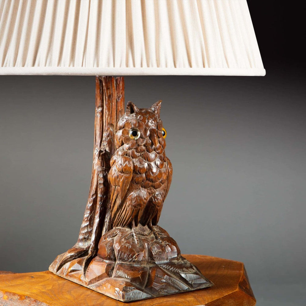 Carved Owl As A Table Lamp featuring a fine 19th century carved owl mounted as a lamp with a fabric shade.