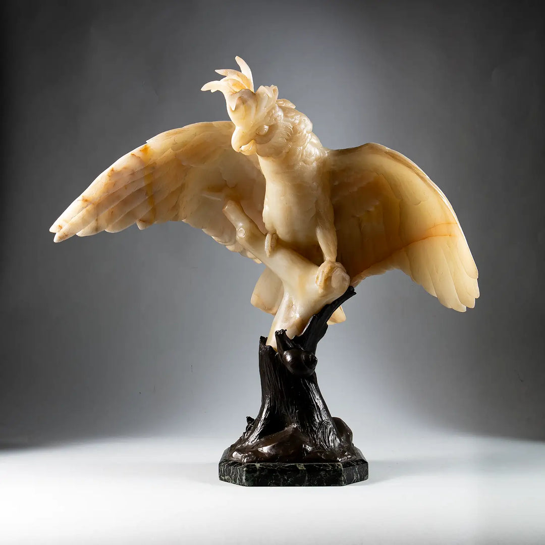 Finely Carved Alabaster Cockatoo Sculpture perched on a bronze tree trunk with detailed feathers and elegant pose
