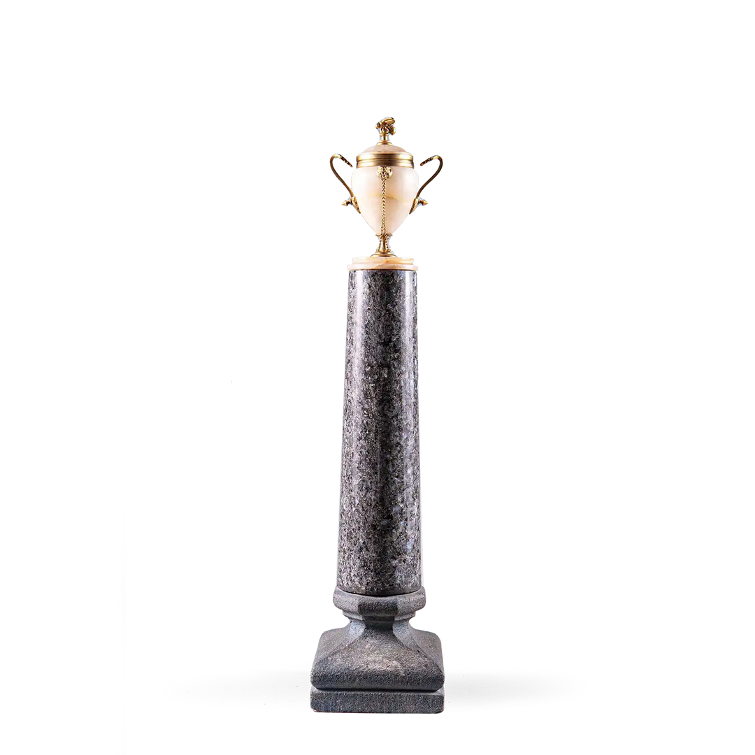 Neoclassical Urn on Granite Pedestal with alabaster body, gilded handles, bee finial, and tall dark granite base.