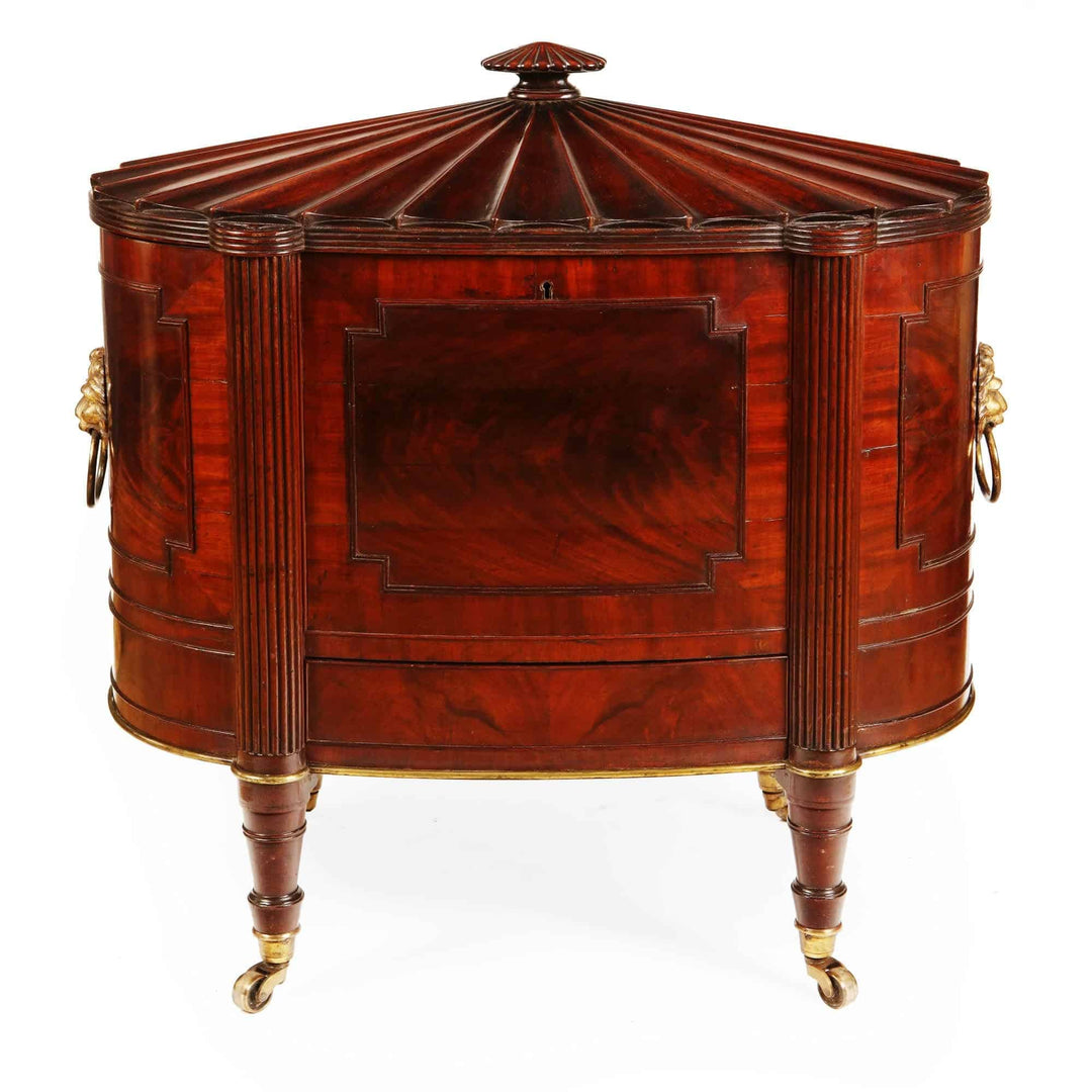 George III Cellarette Attributed To Gillows, oval mahogany cabinet with reeded legs and brass lion handles, circa 1800.