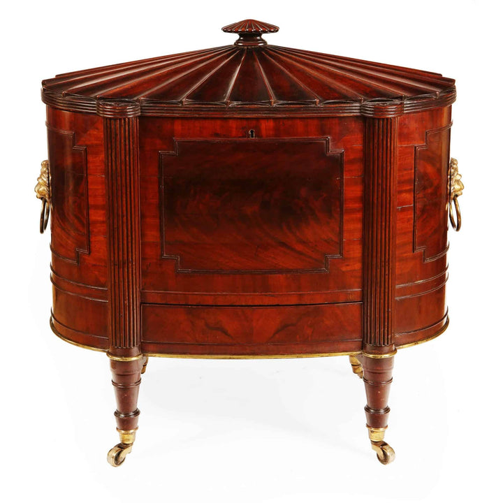 George III Cellarette Attributed To Gillows, oval mahogany cabinet with reeded legs and brass lion handles, circa 1800.