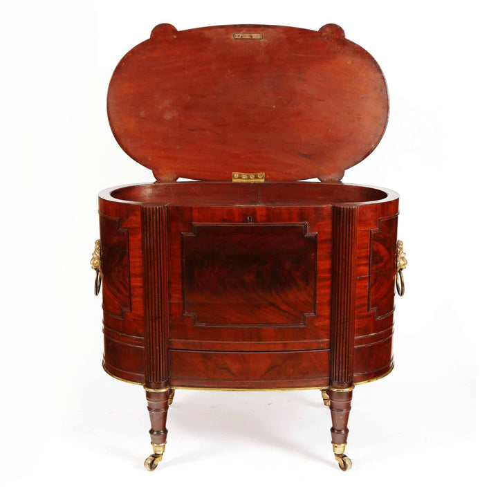 George III Cellarette Attributed To Gillows, mahogany oval cabinet with hinged lid and brass lion ring handles circa 1800.
