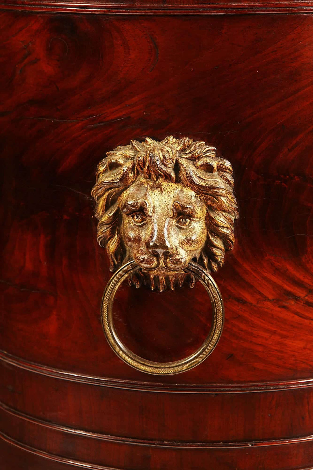 George III Cellarette Attributed To Gillows detailed close-up of lion head brass ring handle on mahogany wood.