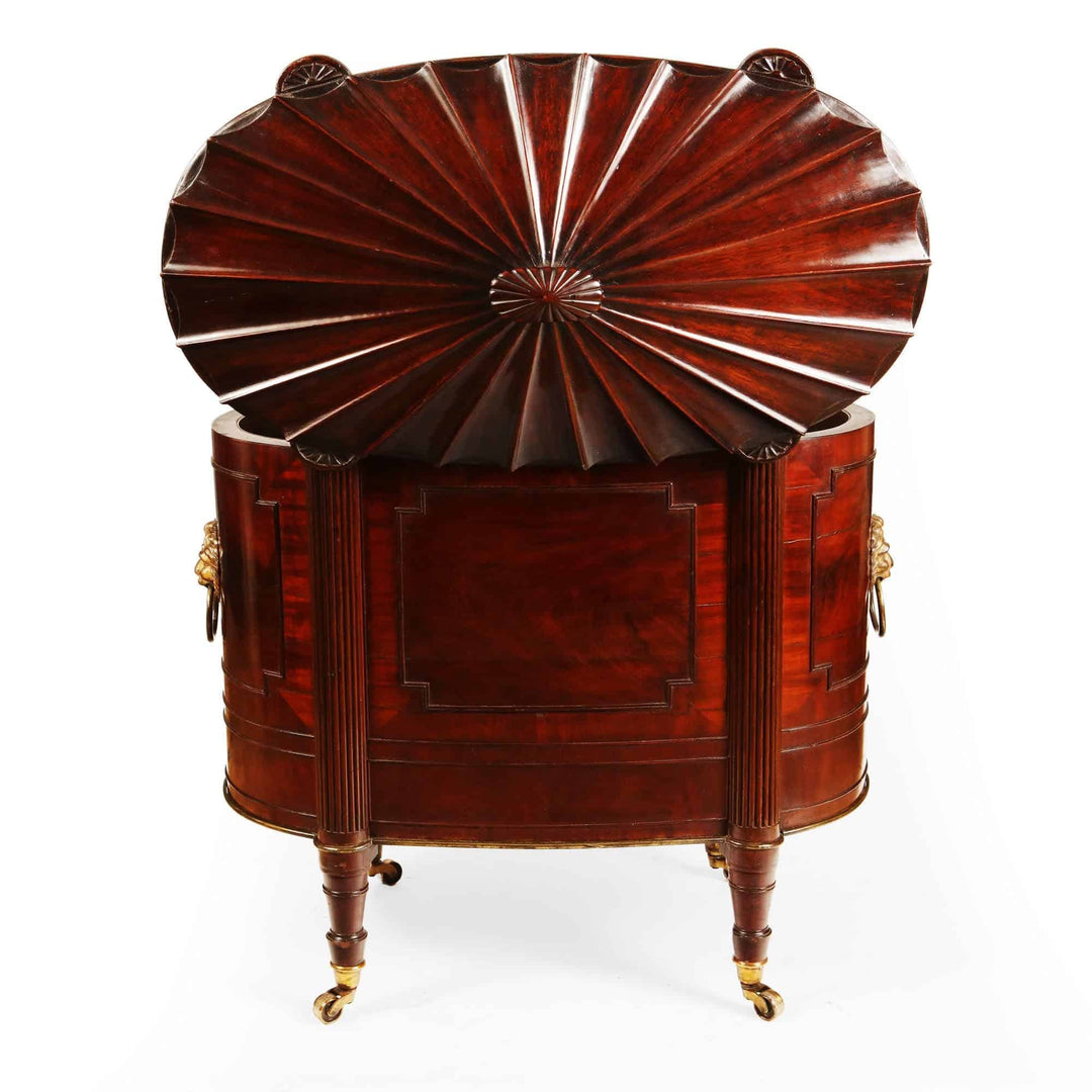 George III Cellarette Attributed To Gillows in mahogany with brass lion handles and reeded legs on casters.
