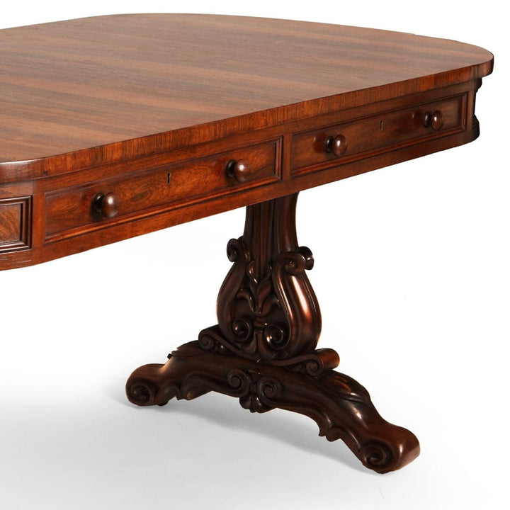 William IV Irish Rosewood Library Table By Williams & Gibton with carved legs and two deep side drawers.