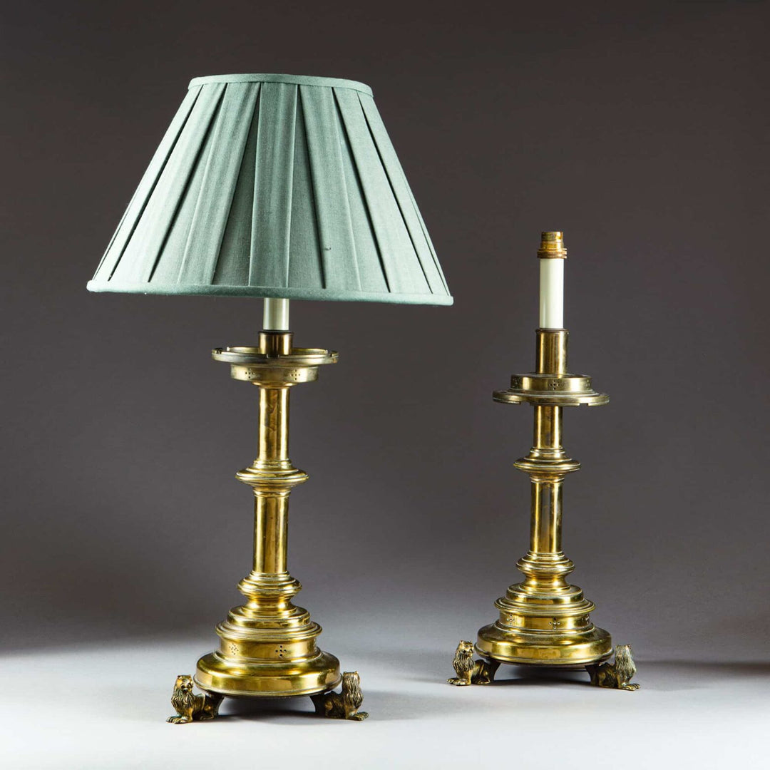A pair of brass table lamps and shades