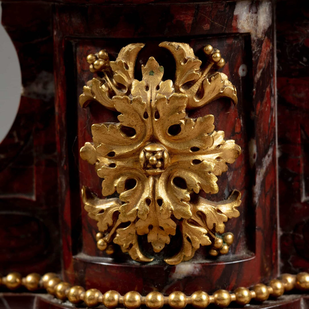 Gilt Bronze and Rosso Francia Marble Candelabra featuring intricate gold leaf detail on rich red marble base.