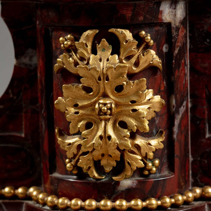 Gilt Bronze and Rosso Francia Marble Candelabra featuring intricate gold leaf detail on rich red marble base.