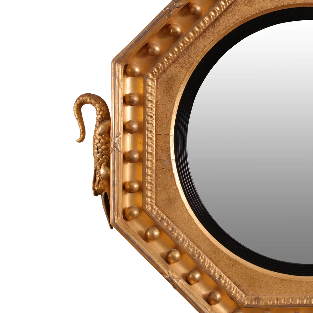 Rare Early 19th Century Regency Octagonal Convex Mirror with giltwood frame and intricate carved details.