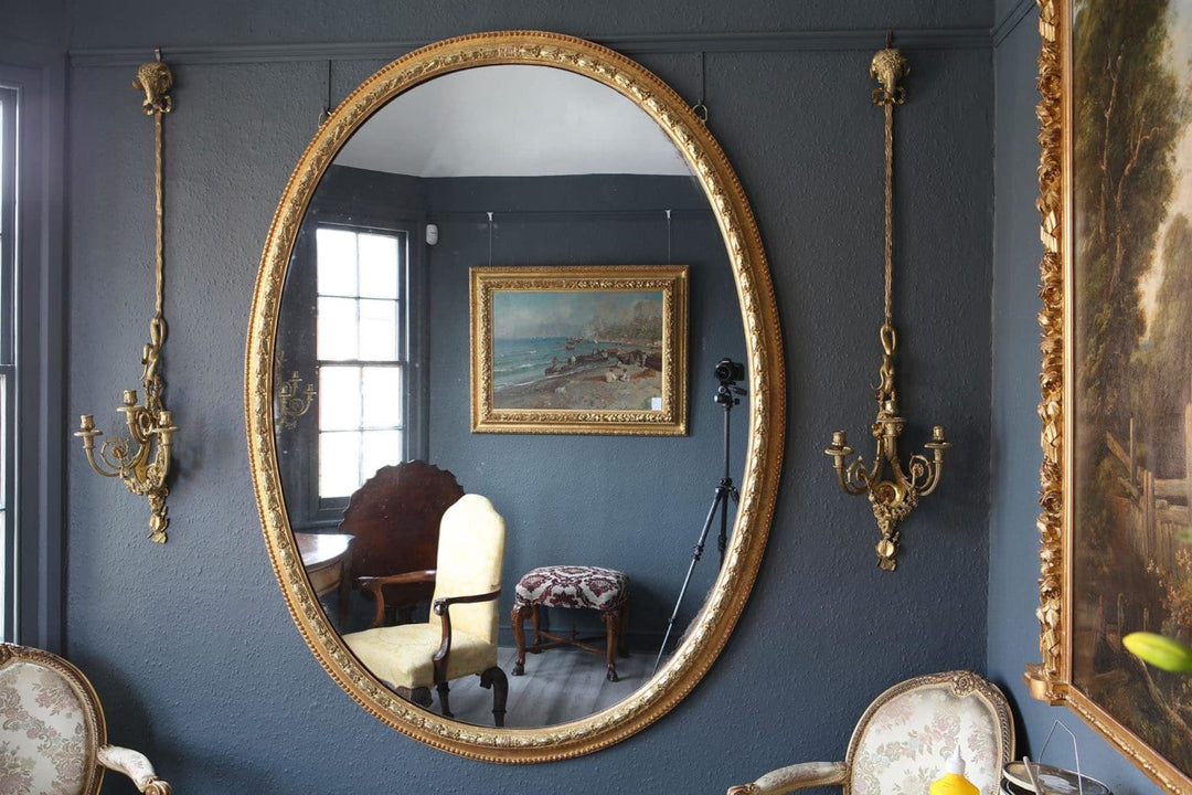 An imposing 19th Century giltwood oval wall mirror