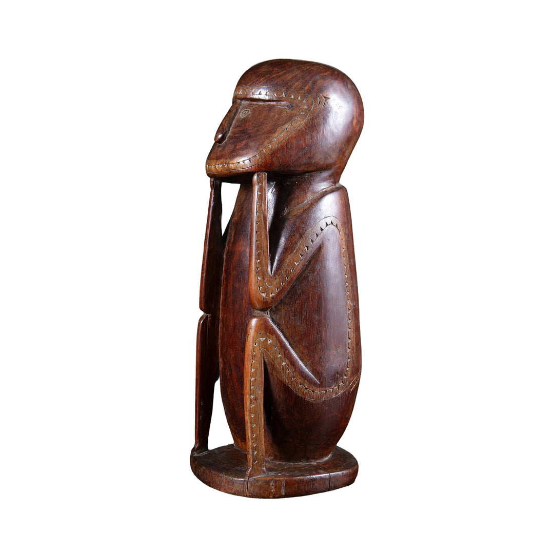 Carved Seated Massim Protective Figure with Lime Inlay