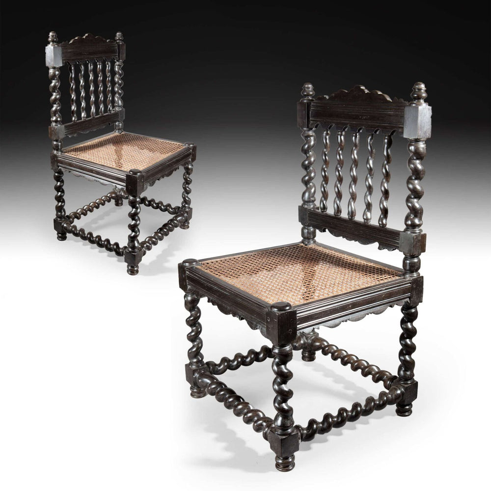 Pair of antique solid ebony Indian hall chairs with cane seats and barley twist legs from Collection EE30