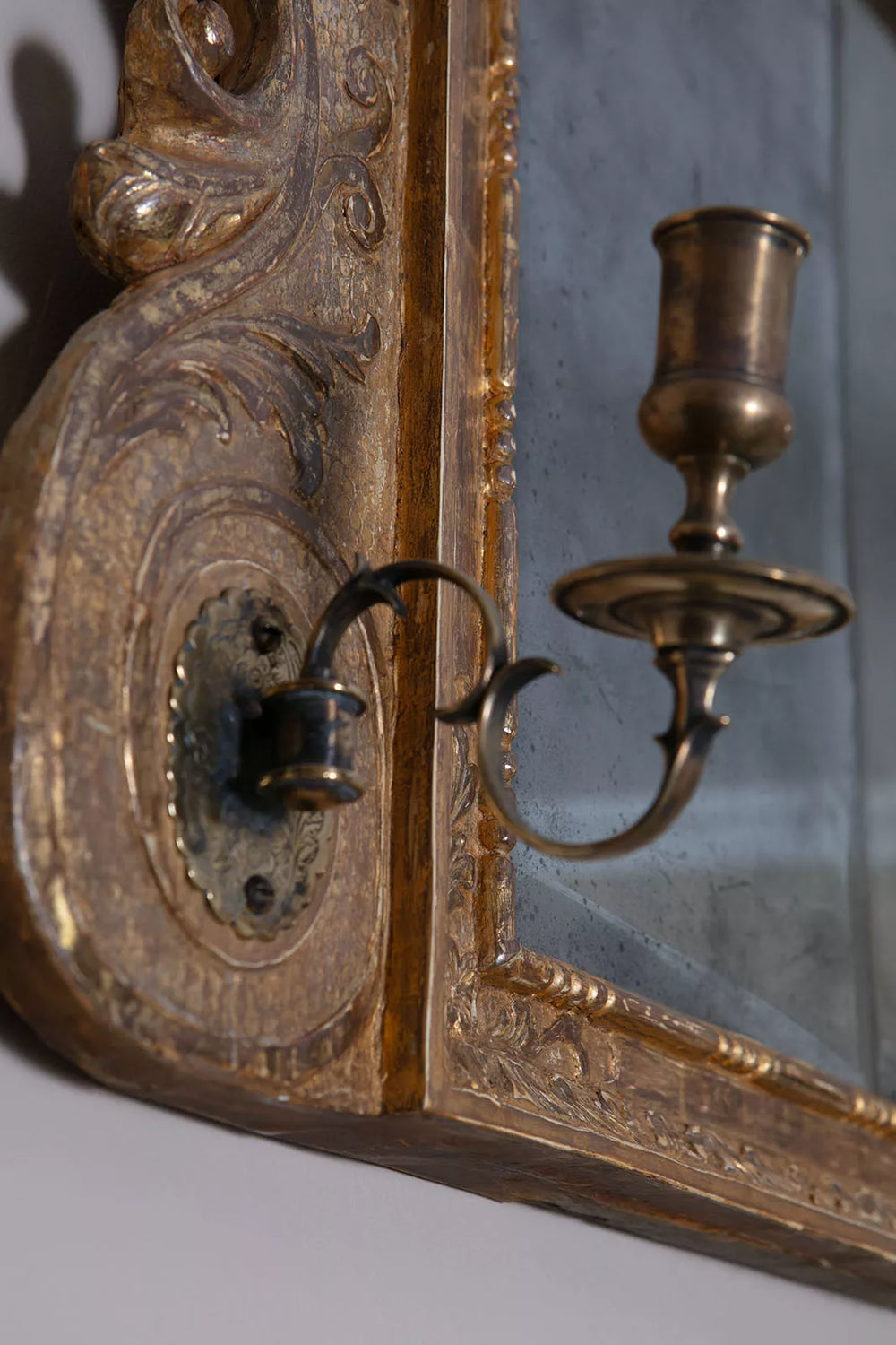 George II Triple Plate Overmantle Mirror close-up of carved giltwood frame and girandole candle arm detail