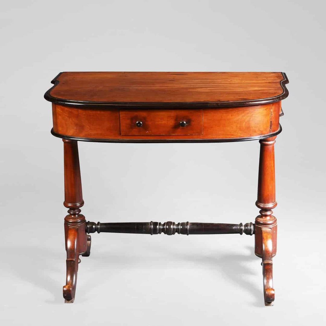Indo Dutch Solid Satinwood and ebony side table with shaped top, ebony mouldings, turned supports, and stretcher circa 1850.