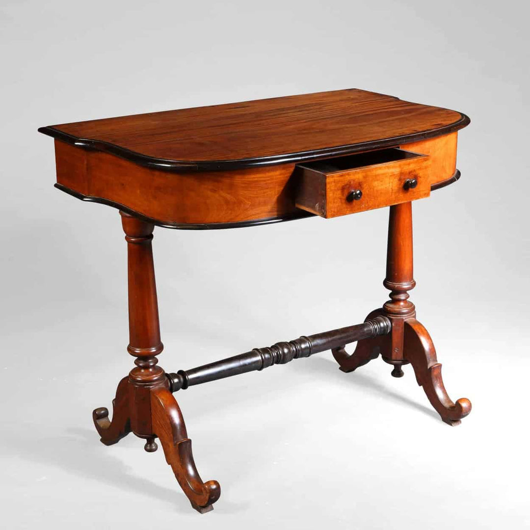 Indo Dutch Solid Satinwood and ebony side table with shaped top, turned end supports, ebony stretcher, and single drawer.