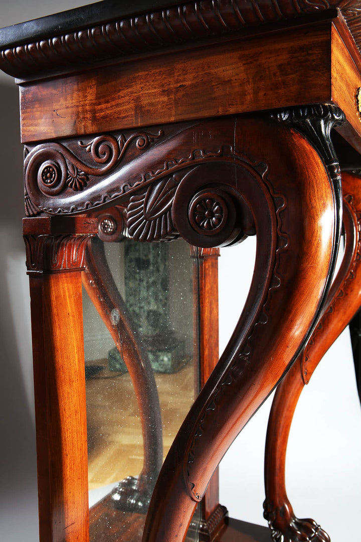 Pair of Regency Pier Console Tables with carved mahogany legs, gilt bronze mounts, and inset mirror backs.