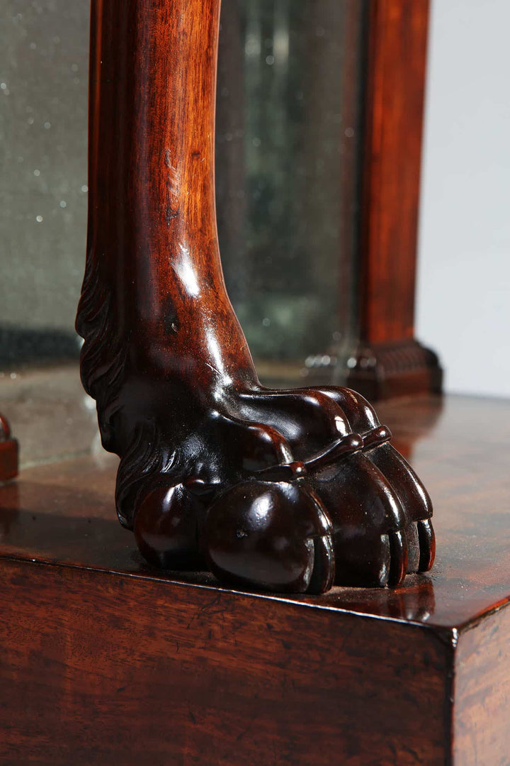 Pair of Regency Pier Console Tables featuring carved lion feet on rich mahogany monopodial legs with gilt bronze mounts.