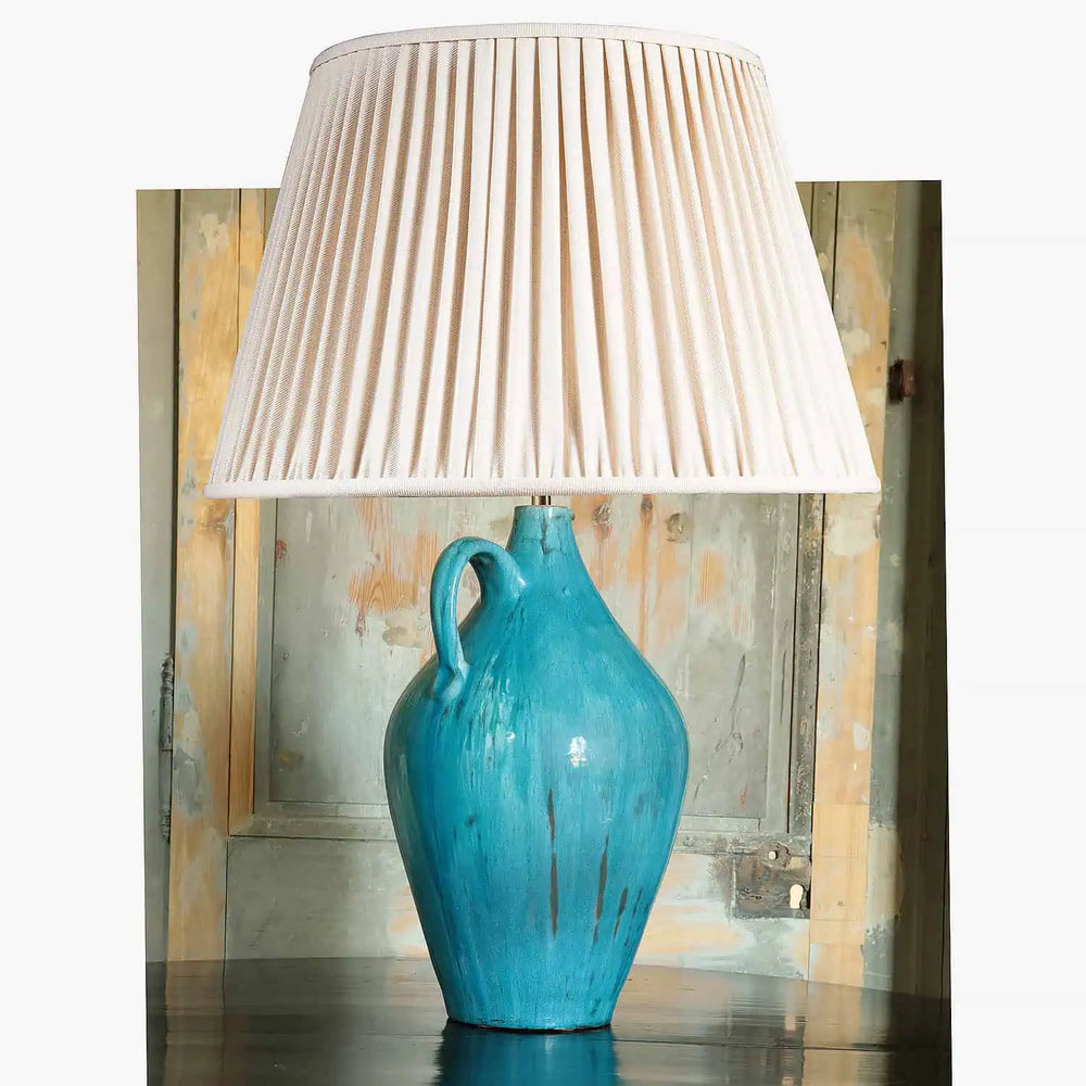 Fantoni Turquoise Glazed Jug table lamp with mid-century pottery design and pleated cream lampshade.