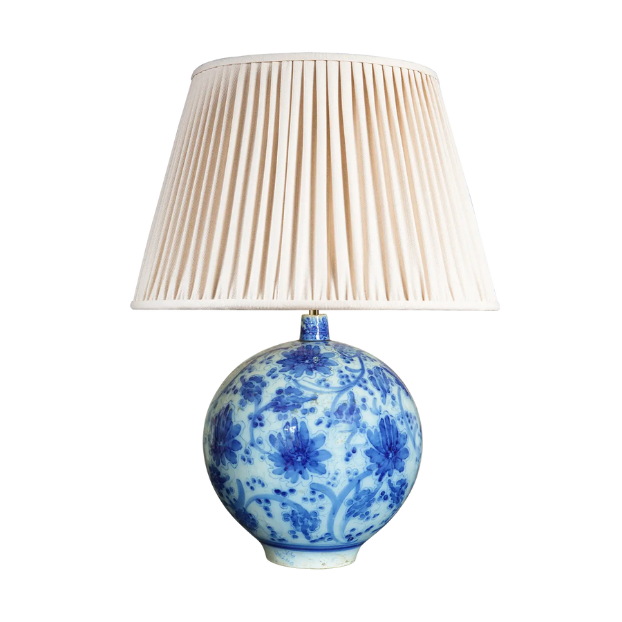 Spanish Blue and White Table Lamp with spherical blue floral vase base and cream pleated lampshade, 33 cm tall.