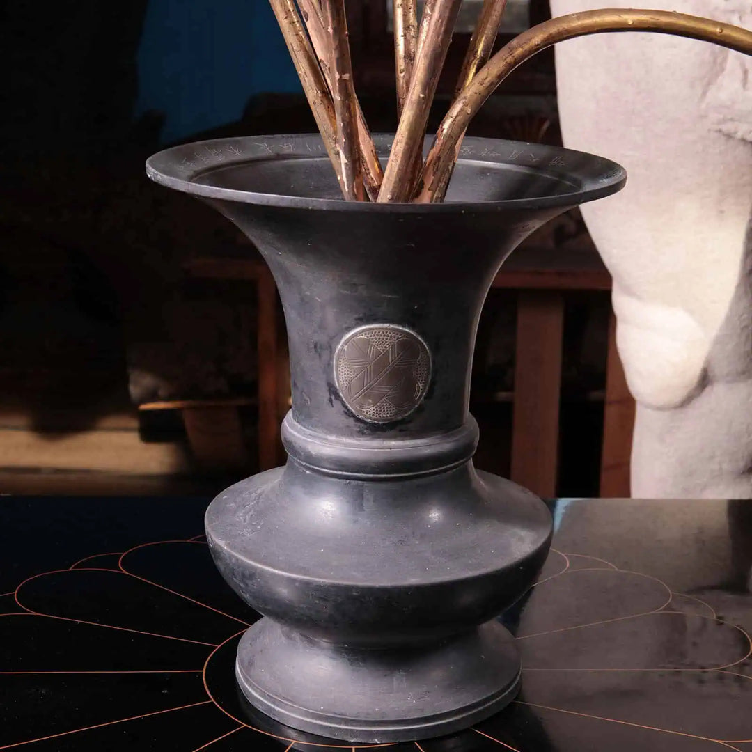 Black bronze vase base from Collection EE20 elegantly supporting gold lacquered wood Jyôka lotus flowers with intricate Buddhist symbolism