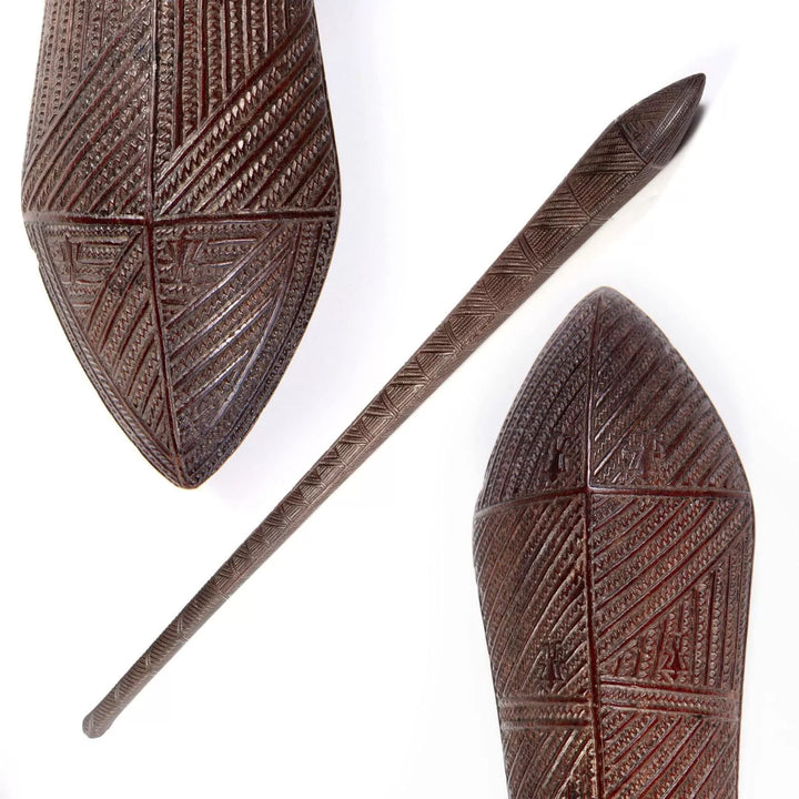 Tongan War Club made of ironwood with intricate geometric shark teeth patterns and six human ideograph glyphs.