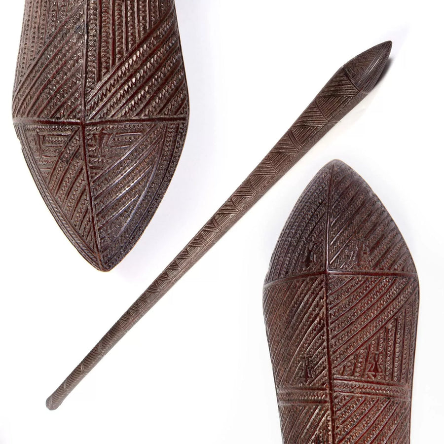 Tongan War Club made of ironwood with intricate geometric shark teeth patterns and six human ideograph glyphs.