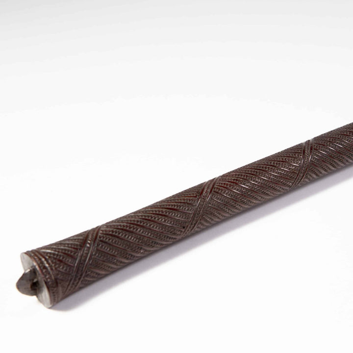 Tongan War Club made of ironwood with intricate geometric patterns and human ideograph glyphs, circa 1800, 120 cm long.