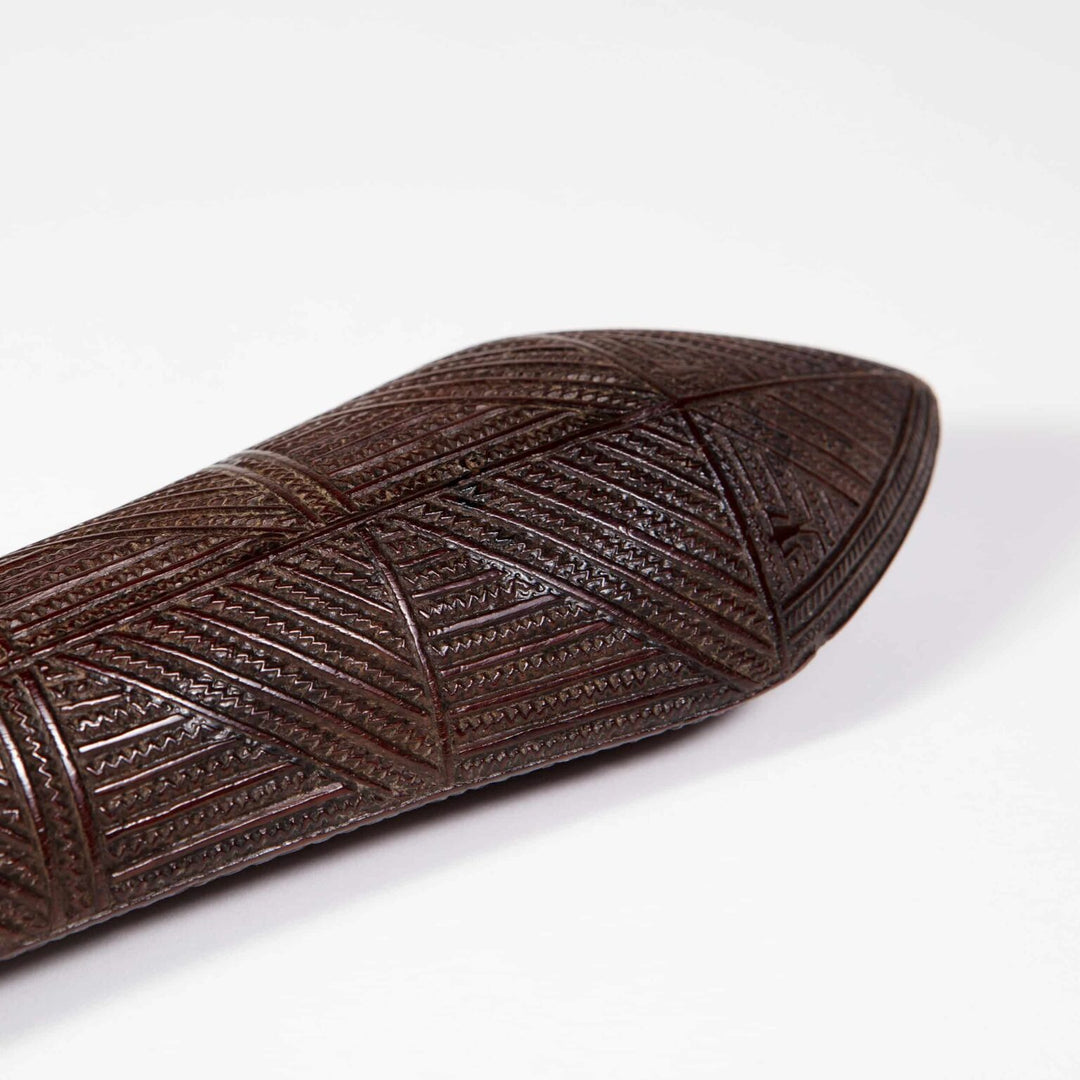 Tongan War Club with intricate geometric incised patterns and human ideograph glyphs on ironwood shaft circa 1800.