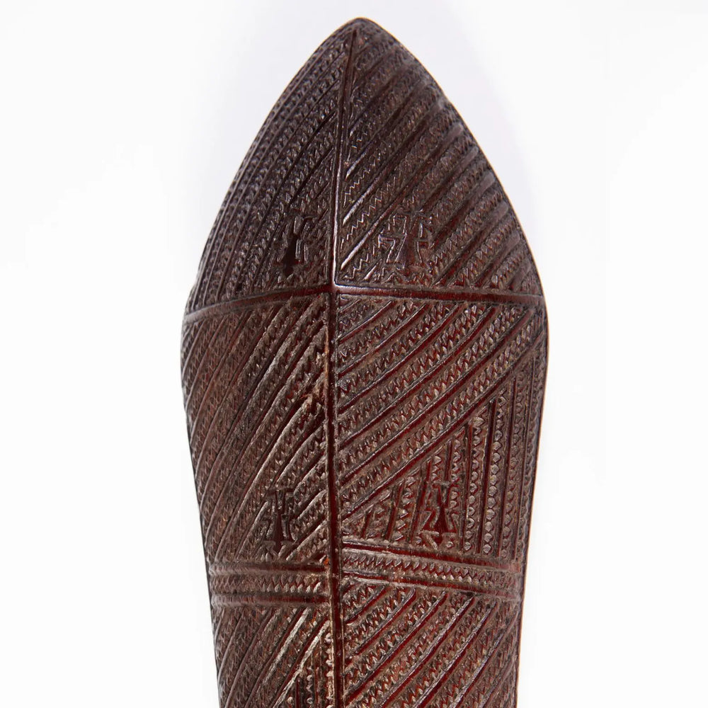 Tongan War Club made of ironwood with intricate shark teeth incised geometric patterns and human ideograph glyphs.