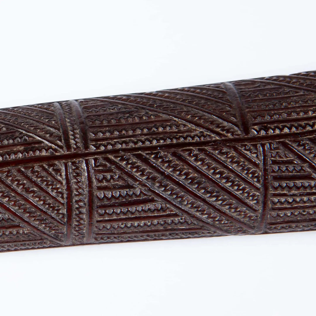 Tongan War Club ironwood detail showing incised geometric patterns and shark teeth motifs from 18th century Polynesia.