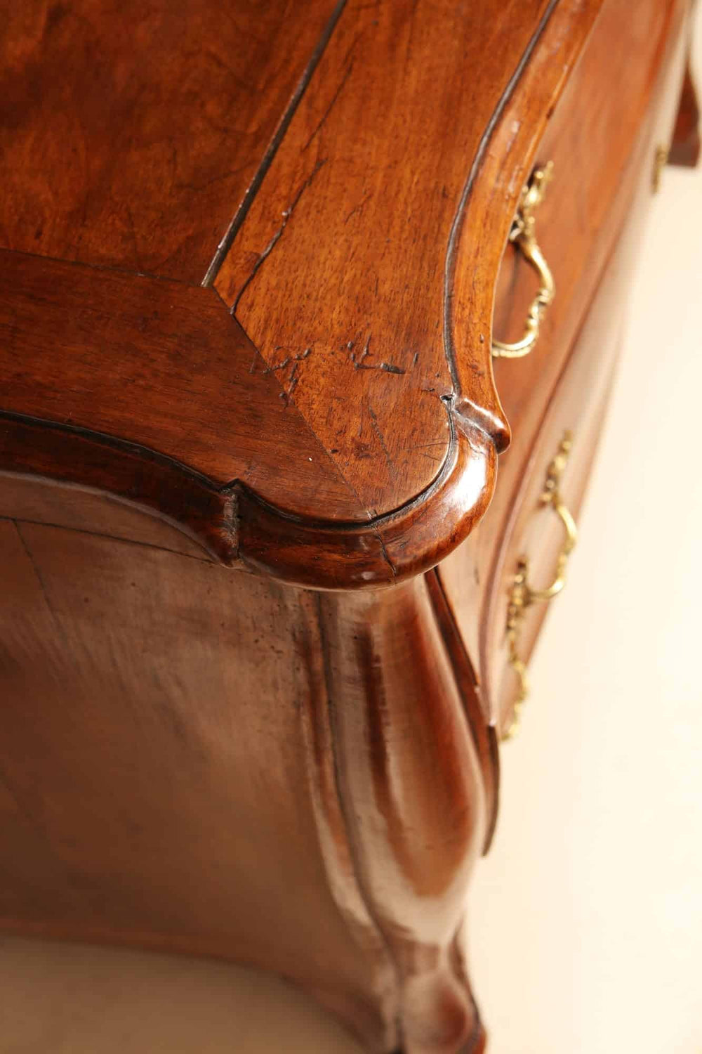 Close-up of Louis XV walnut veneered commode with ornate drawer handles by Nicholas Wells Antiques