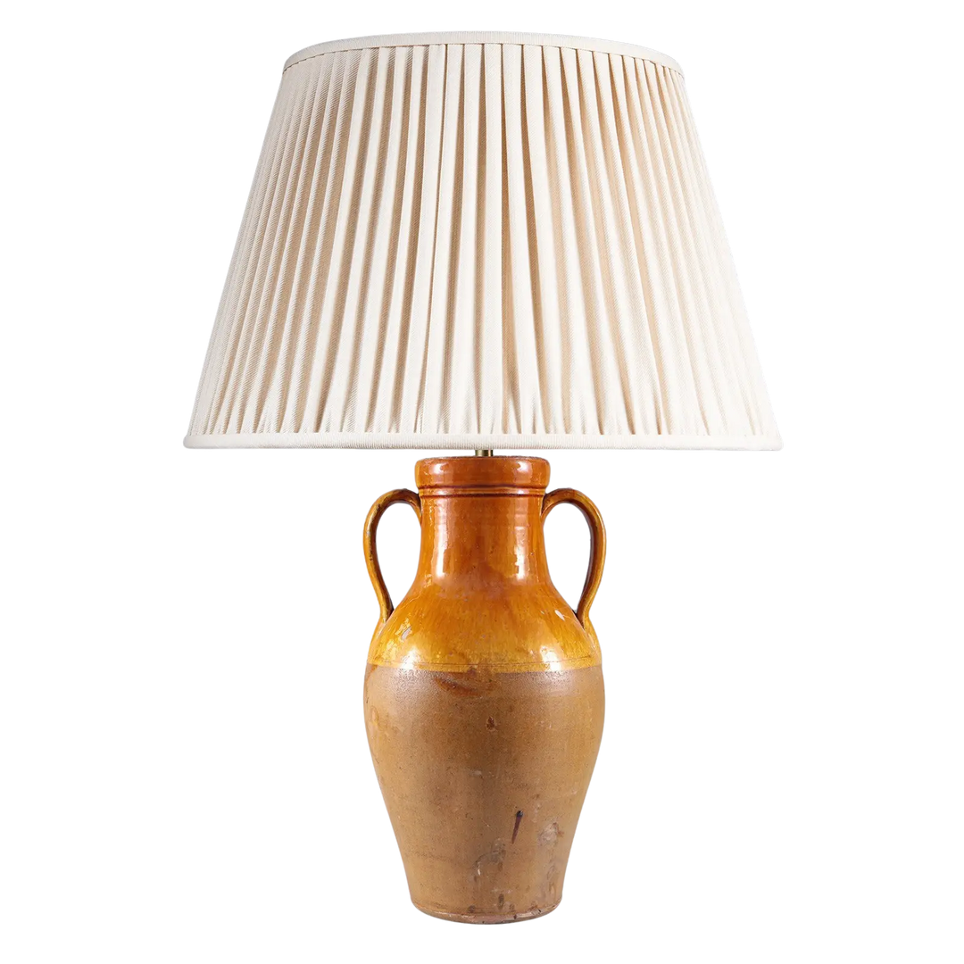 Yellow Umber Glazed Amphora Vase Mounted as a Table Lamp with two handles and pleated cream lampshade.