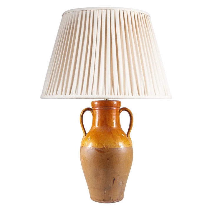 Yellow Umber Glazed Amphora Vase Mounted as a Table Lamp with two handles and pleated cream lampshade.