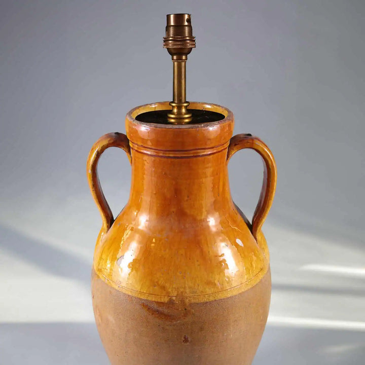 Yellow Umber Glazed Amphora Vase Mounted as a Table Lamp with loop handles and classic olive jar shape, circa 1880.