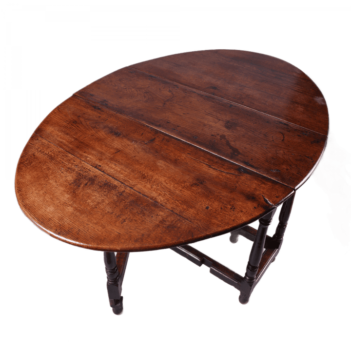 17th Century Oak drop leaf table with turned legs and stretchers, oval top in rich oak wood finish.